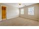Spacious bedroom with ensuite bathroom access and two windows for natural light at 1611 Threepine Pl, Lilburn, GA 30047