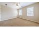 Bedroom with large windows letting in natural light, neutral carpet and ceiling fan at 1611 Threepine Pl, Lilburn, GA 30047