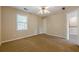 This bedroom has neutral paint, large window, and a ceiling fan with lights at 1611 Threepine Pl, Lilburn, GA 30047