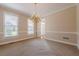 Dining room featuring crown molding, a chandelier and large windows providing natural light at 1611 Threepine Pl, Lilburn, GA 30047