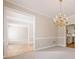 Dining room with hardwood floors, chandelier, and decorative trim at 1611 Threepine Pl, Lilburn, GA 30047