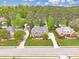 Aerial view of a well-kept brick home with green lawn, surrounded by mature trees at 1611 Threepine Pl, Lilburn, GA 30047