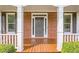 Inviting front porch with sturdy columns, wood flooring, and charming curb appeal, perfect for relaxing outdoors at 1611 Threepine Pl, Lilburn, GA 30047