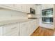 Updated kitchen features granite countertops, stainless appliances, and white cabinets at 1611 Threepine Pl, Lilburn, GA 30047