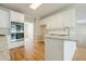 Bright kitchen with granite countertops, stainless appliances, and white cabinets at 1611 Threepine Pl, Lilburn, GA 30047