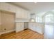 Kitchen area features white cabinets, stainless steel appliances, and hardwood floors at 1611 Threepine Pl, Lilburn, GA 30047