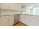 Kitchen with stainless steel appliances, granite countertops, white cabinets, and hardwood flooring at 1611 Threepine Pl, Lilburn, GA 30047
