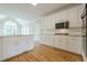 Modern kitchen boasting white cabinets, stainless steel appliances, and granite countertops, perfect for cooking at 1611 Threepine Pl, Lilburn, GA 30047