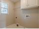 Functional laundry room with overhead cabinet for convenient storage at 1611 Threepine Pl, Lilburn, GA 30047