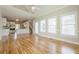 Open-concept living space with hardwood floors and bright windows at 1611 Threepine Pl, Lilburn, GA 30047