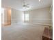 Bright and airy living room with neutral carpet, white trim, and large windows for natural light at 1611 Threepine Pl, Lilburn, GA 30047