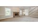 Inviting living room featuring a brick fireplace, large windows, and staircase leading to the second floor at 1611 Threepine Pl, Lilburn, GA 30047
