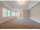 Spacious main bedroom with tray ceilings and carpeted floors at 1611 Threepine Pl, Lilburn, GA 30047
