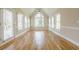 Sunroom features hardwood floors, a vaulted ceiling, and large windows for abundant natural light at 1611 Threepine Pl, Lilburn, GA 30047