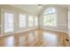 Sunroom features hardwood floors, a vaulted ceiling, and large windows for abundant natural light at 1611 Threepine Pl, Lilburn, GA 30047