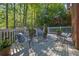 Inviting back deck with stylish metal furniture, potted plants, and a serene, shaded ambiance perfect for outdoor relaxation at 2473 Kings Arms Dr, Atlanta, GA 30345