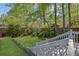 Spacious backyard showcasing a graded landscape, a meticulously maintained lawn, and a charming staircase leading to the deck at 2473 Kings Arms Dr, Atlanta, GA 30345