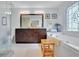 A bathroom with a large vanity and soaking tub has lots of natural light from a stained glass window at 2473 Kings Arms Dr, Atlanta, GA 30345