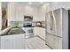 Bright kitchen featuring white cabinets, stainless steel appliances, and black granite countertops at 2473 Kings Arms Dr, Atlanta, GA 30345