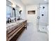 This bright bathroom features a dual sink vanity, sleek fixtures, and glass-enclosed shower at 521 Smithstone Se Rd, Marietta, GA 30067