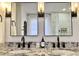 Bathroom featuring double sinks, modern fixtures, granite countertop, and wall-mounted vanity lights at 521 Smithstone Se Rd, Marietta, GA 30067