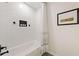 Bathroom featuring a tub with hexagon tile walls, black fixtures, and a white patterned shower curtain at 521 Smithstone Se Rd, Marietta, GA 30067