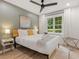 Bedroom featuring a bed, ceiling fan, side table, large window, and wood-look flooring at 521 Smithstone Se Rd, Marietta, GA 30067
