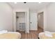 Cozy bedroom featuring twin beds, an open closet, and neutral décor with wood-look floors at 521 Smithstone Se Rd, Marietta, GA 30067