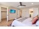 Bedroom with a ceiling fan, mounted TV, walk-in closet, and ensuite bathroom with dual sinks at 521 Smithstone Se Rd, Marietta, GA 30067