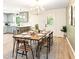 Bright dining area with modern chandelier, wood table, and views into the modern kitchen at 521 Smithstone Se Rd, Marietta, GA 30067