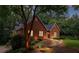 Charming brick home with manicured landscaping and inviting walkway lighting, creating a warm and welcoming curb appeal at 521 Smithstone Se Rd, Marietta, GA 30067
