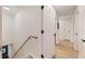Bright hallway with wood-look flooring and white doors, leading to different rooms at 521 Smithstone Se Rd, Marietta, GA 30067