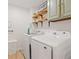 Efficient laundry room with modern machines, wood shelves and ample storage space at 521 Smithstone Se Rd, Marietta, GA 30067