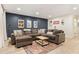 Spacious living room boasts a large sectional, stylish rug, and accent wall décor at 521 Smithstone Se Rd, Marietta, GA 30067