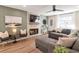 Cozy living room with stone fireplace, comfortable seating, and natural light from large windows at 521 Smithstone Se Rd, Marietta, GA 30067