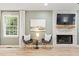 Living room featuring a stone fireplace, comfortable seating, and ample natural light through a window at 521 Smithstone Se Rd, Marietta, GA 30067