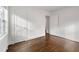 Empty bedroom showcasing hardwood floors, fresh white paint, and ample natural light at 1612 Alder Se Ct, Atlanta, GA 30317