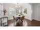 Charming dining area featuring hardwood floors, white wainscoting, and a stylish modern light fixture at 1612 Alder Se Ct, Atlanta, GA 30317