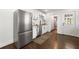 Modern kitchen with stainless steel refrigerator, white cabinets, and an efficient layout for easy cooking at 1612 Alder Se Ct, Atlanta, GA 30317