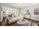 Bright living room with white walls, hardwood floors, neutral sofa, and floods of natural light at 1612 Alder Se Ct, Atlanta, GA 30317