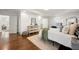 Spacious bedroom featuring a tray ceiling, neutral tones, hardwood floors, and modern furnishings at 1612 Alder Se Ct, Atlanta, GA 30317