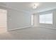 Spacious bedroom with a large window, carpet flooring, and white trim at 170 Bluffington Way, Marietta, GA 30066