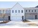 Charming townhome featuring a two-car garage, modern facade, and well-manicured landscaping at 170 Bluffington Way, Marietta, GA 30066