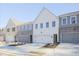 Modern townhome exterior showcases a two-car garage and neutral color palette at 170 Bluffington Way, Marietta, GA 30066