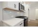 White kitchen with stainless steel microwave and range, with stylish subway tile backsplash at 170 Bluffington Way, Marietta, GA 30066