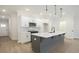A kitchen featuring an island with light countertops, white cabinets, and hardwood floors at 170 Bluffington Way, Marietta, GA 30066