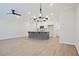 Open-concept room with light hardwood floors, chandelier and fan for style and comfort at 170 Bluffington Way, Marietta, GA 30066