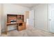 Bedroom featuring neutral carpet and a built-in wooden desk with shelving unit at 2206 Palomino Ln, Conyers, GA 30012
