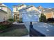 Charming two-story home with a two-car garage, stone accents, and landscaped front yard at 2206 Palomino Ln, Conyers, GA 30012