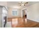 Bright living room with hardwood floors, fireplace, ceiling fan, chandelier and view to kitchen at 2206 Palomino Ln, Conyers, GA 30012